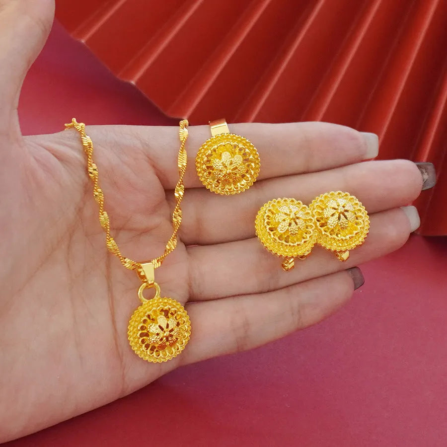 Gold-plated three-piece jewellery set with floral design pendant, matching earrings and ring on water wave chain