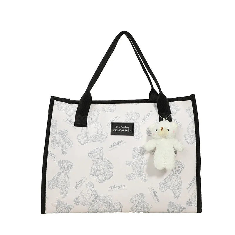 Women's black canvas tote bag with rhombus print pattern and shoulder strap