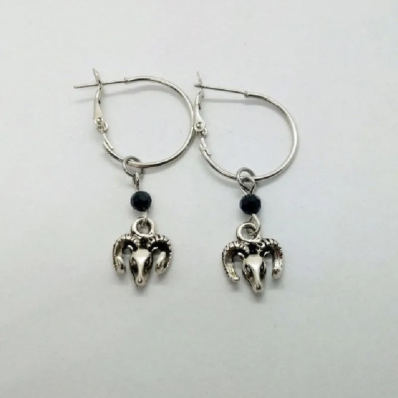 A pair of silver-coloured round ring earrings with a Tibetan Antelope inspired design.