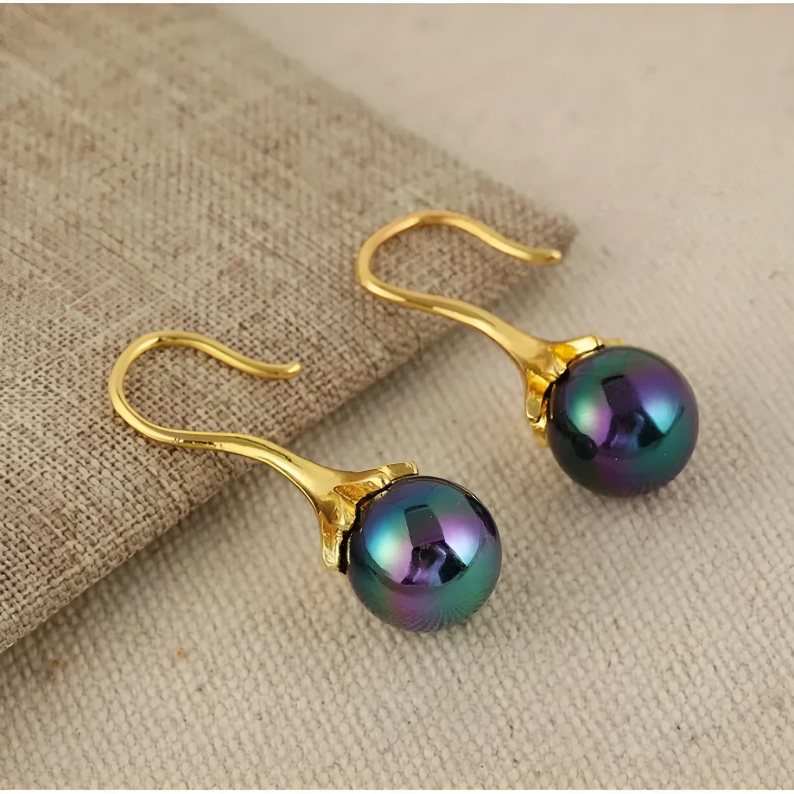 Pair of retro-style gold-coloured fashion earrings for women with creative design.