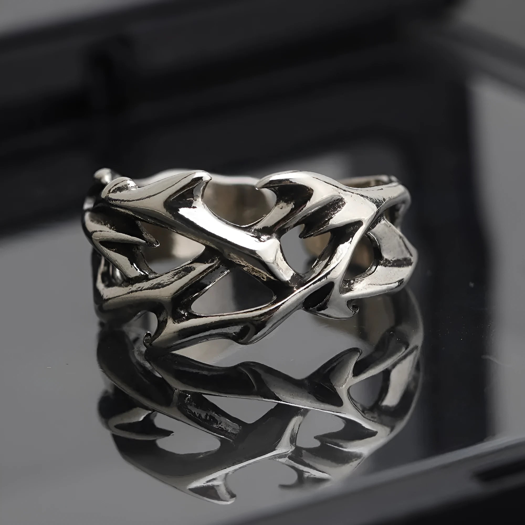 Copper thorn flower geometric ring with adjustable opening on a flat surface.