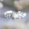 White alloy women's heart-shaped ring with a flower opal ocean design centrepiece.