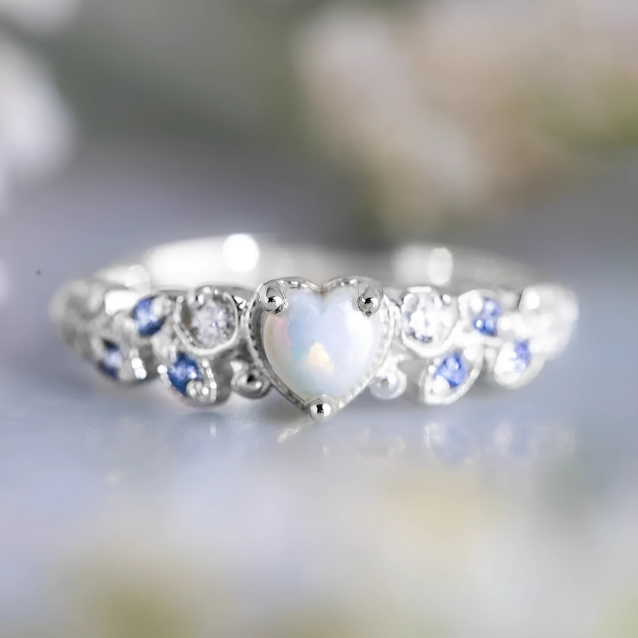 White alloy women's heart-shaped ring with a flower opal ocean design centrepiece.