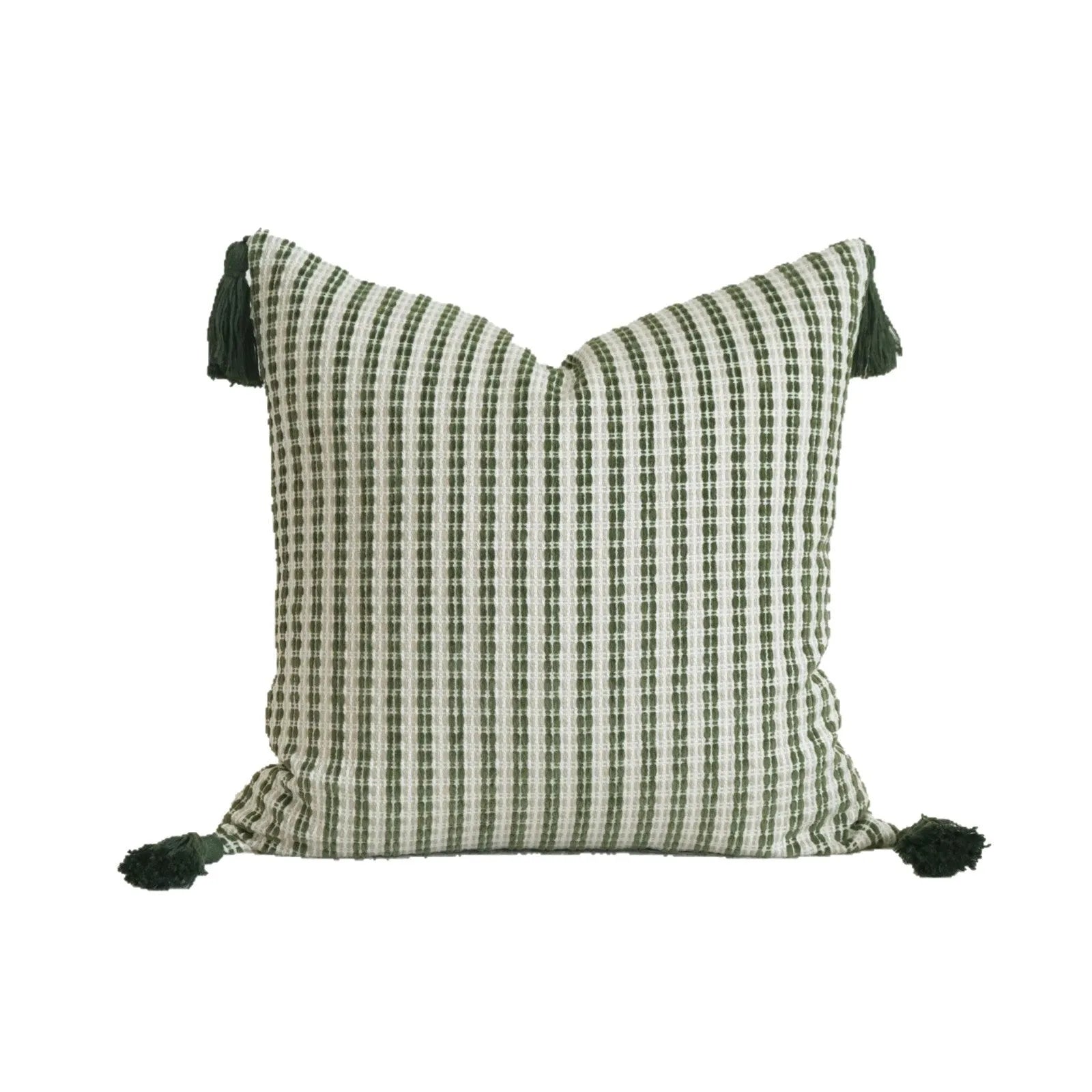 Green cotton and linen hotel pillow with striped or leaf pattern tassel detail on a bed.
