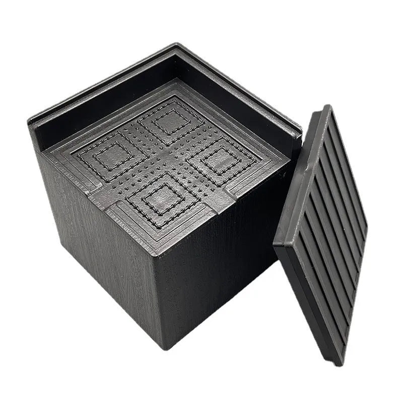 Four black plastic bed foot mats for sofa height increase on hard flooring