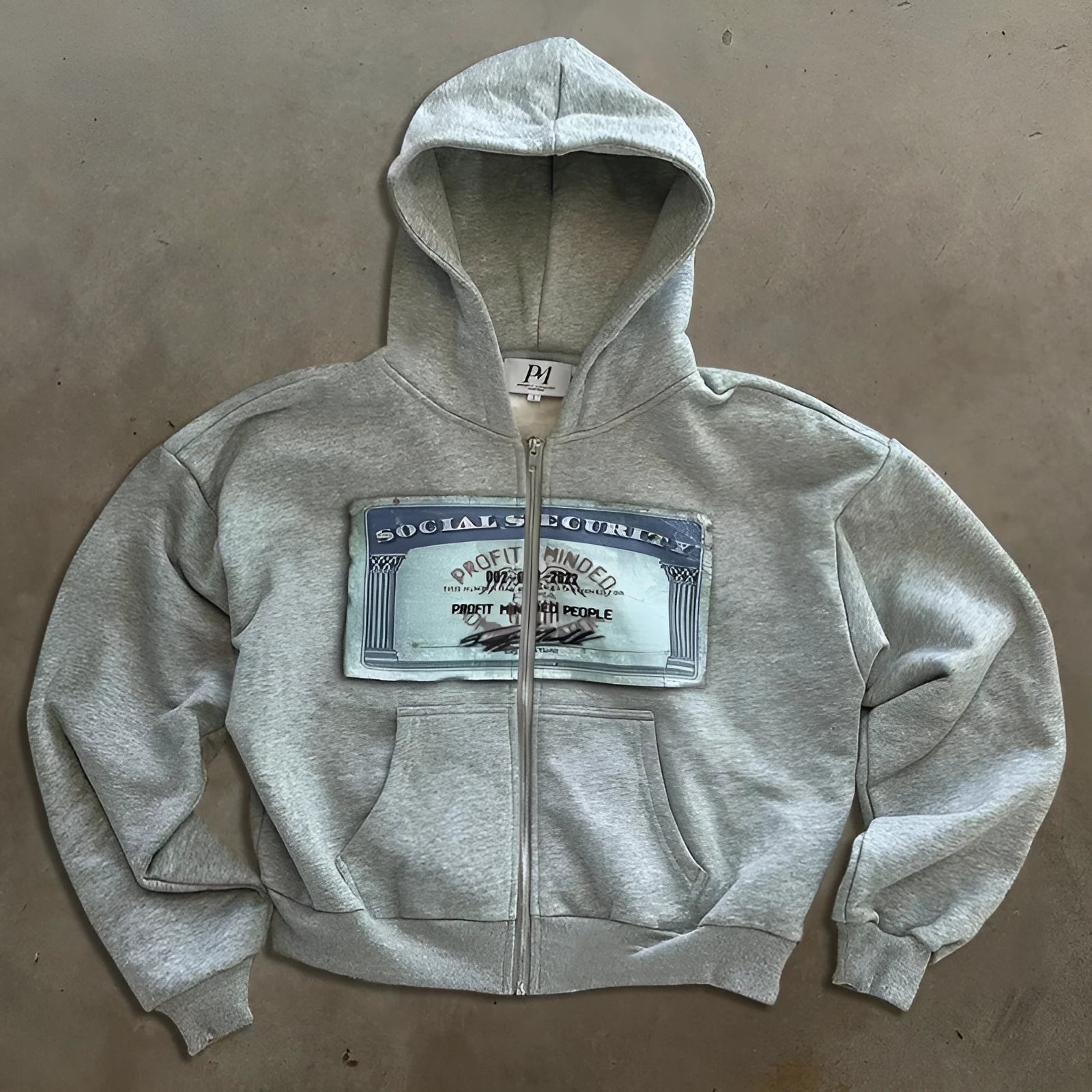 Unisex loose fit hooded zipper jacket in black, grey, or pink with a letter pattern and front pocket.