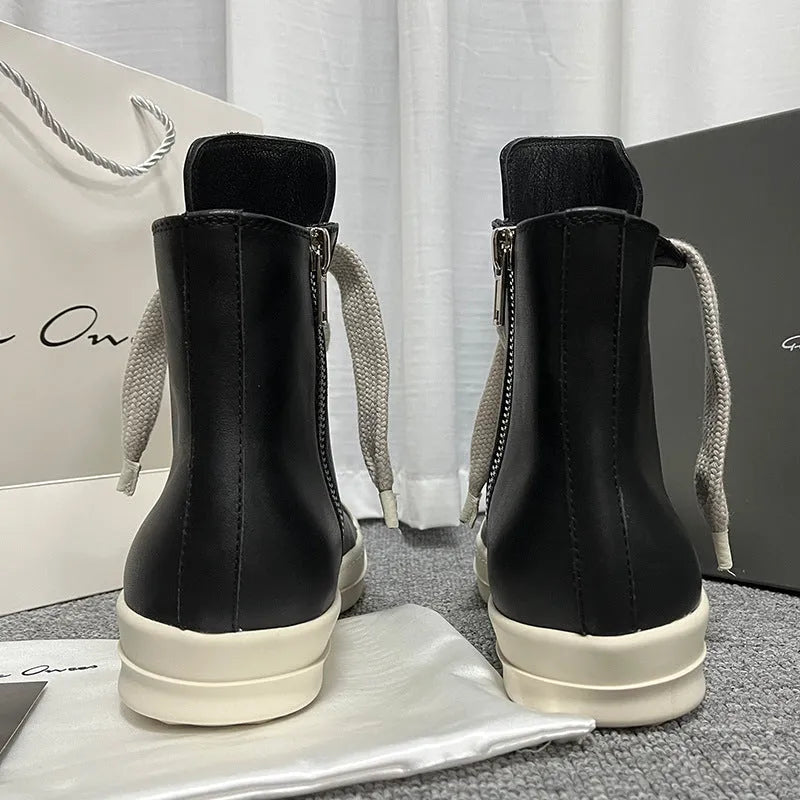 Black high-top leather sneakers with a side zipper and round toe on a rubber sole.