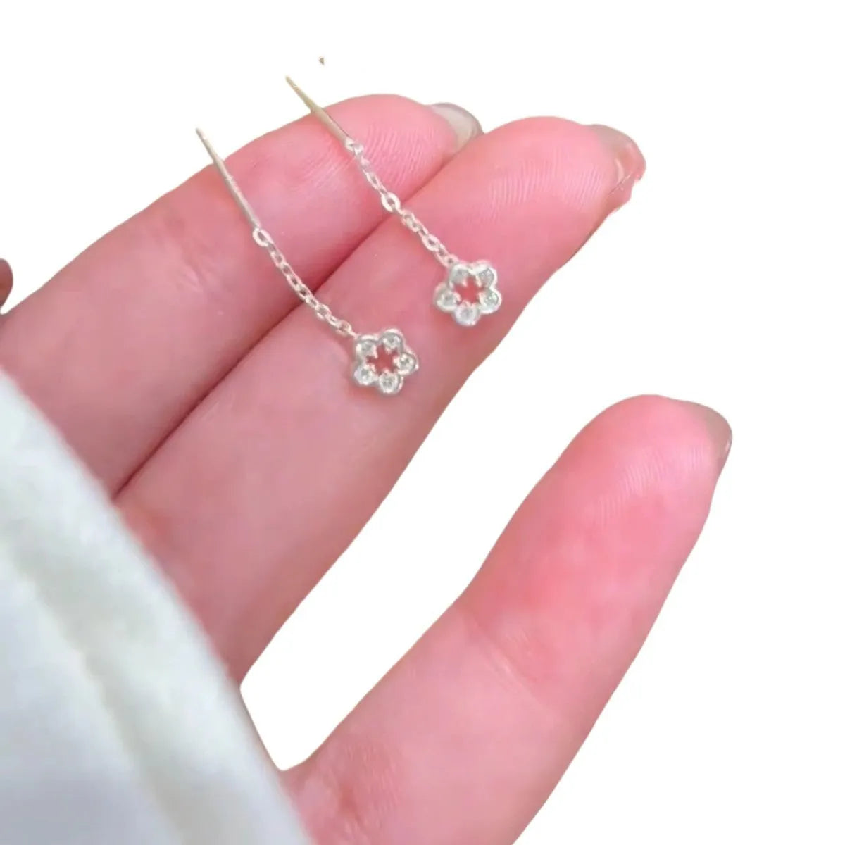 Silver hollow flower dangling earrings with petal design on sterling silver posts