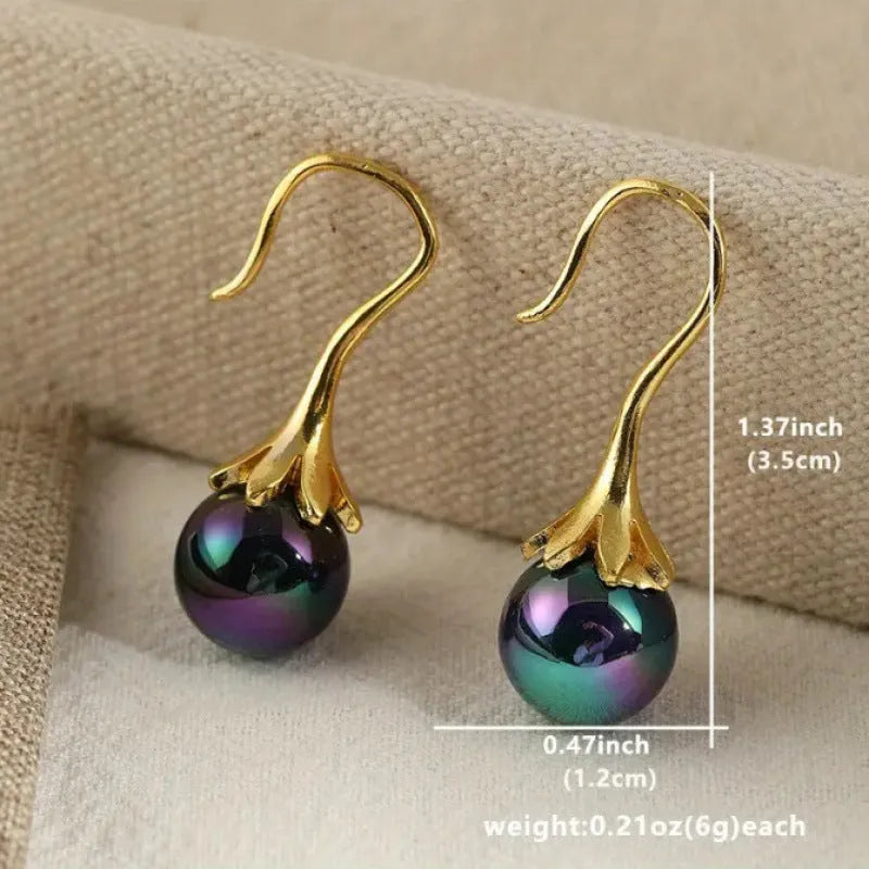 Pair of retro-style gold-coloured fashion earrings for women with creative design.