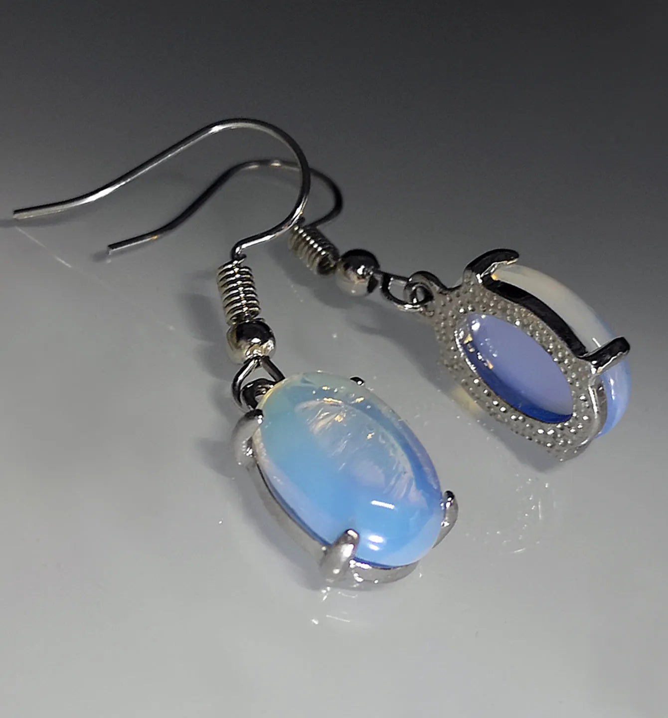 Opal earrings with retro moonstone aesthetic, cross design and ellipse pendant in drop shape
