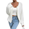 White women's V-neck polyester cardigan on a hanger, showing solid colour and knit texture.