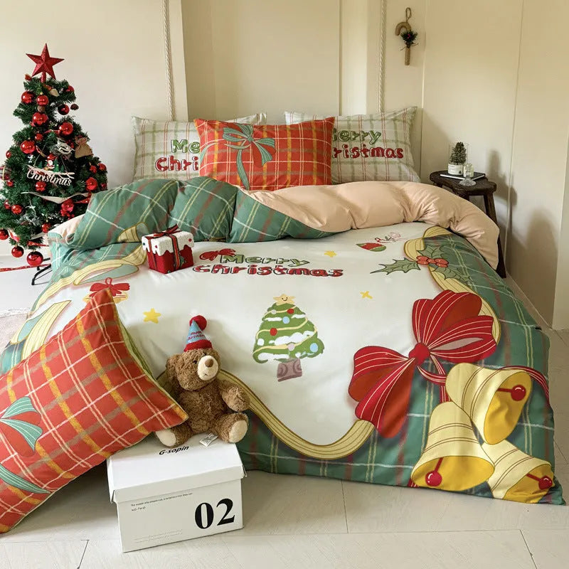 Christmas cartoon themed four-piece bedding set with duvet cover, fitted sheet and pillowcases on a bed.