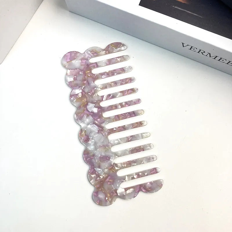Acetate hair comb with geometric retro wave design in various colours.