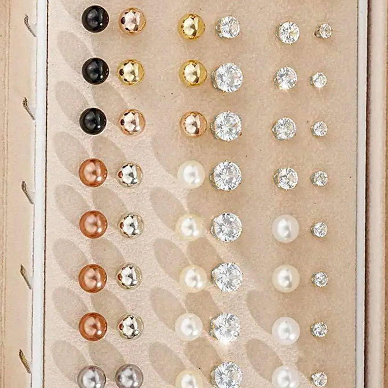 108 gold and yellow geometric alloy earrings with round bead details laid out flat.