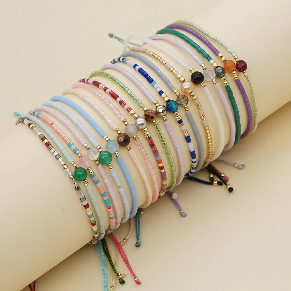 Handmade bohemian bracelet with colourful semi-precious stones and glass beads in geometric patterns.
