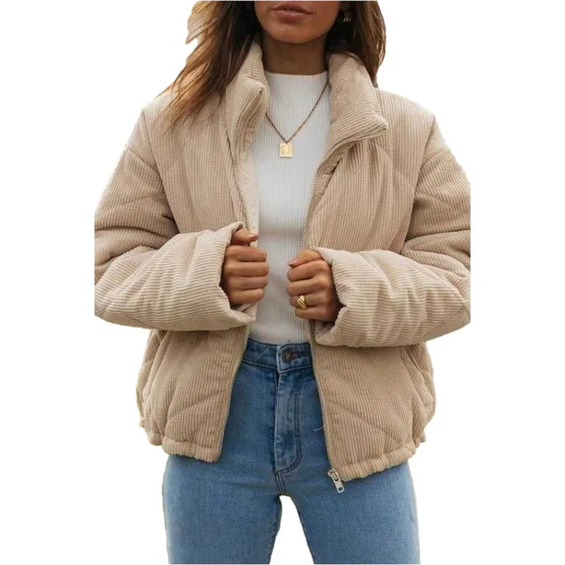 Apricot coloured women's corduroy zip jacket with stand collar and long sleeves on a hanger.