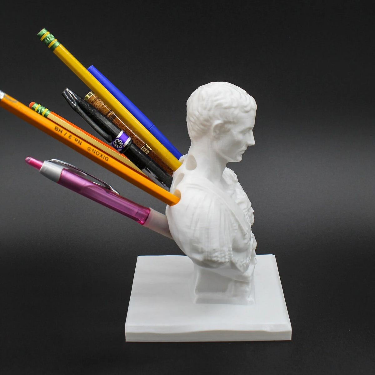 White synthetic resin statue-style pen holder with 15-pen capacity for desk storage