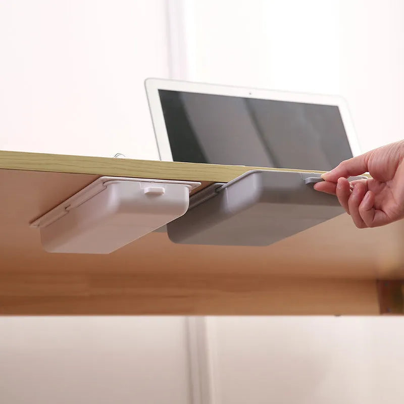 Plastic under-table storage drawer with lid open, showing internal grid, in choice of colours.