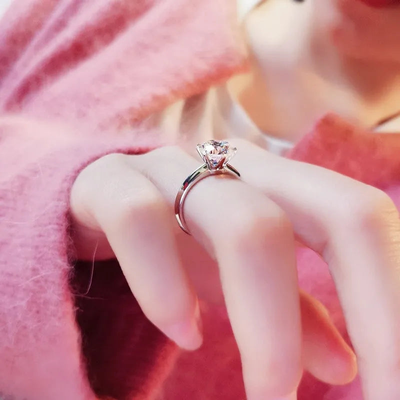 White gold plated women's ring with six-claw zircon setting and geometric band design