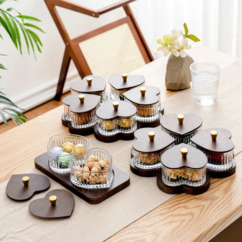 Glass snack platter with choice of 2, 3, 4, or 5 transparent heart-shaped bowls with lids on an irregular tray.
