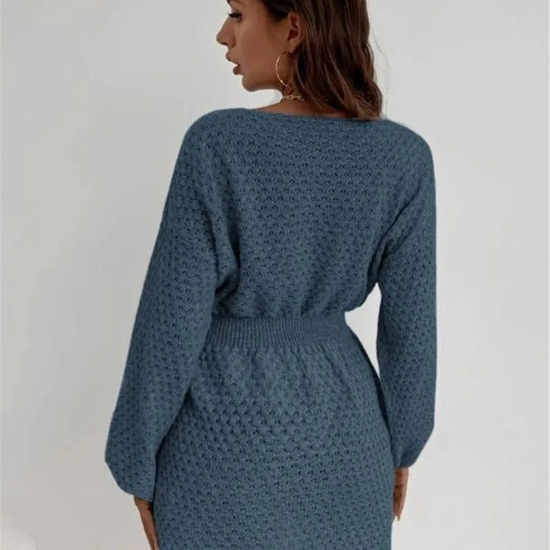 Blue women's knitted dress with hand-crocheted flowers, fitted waist, and round neckline