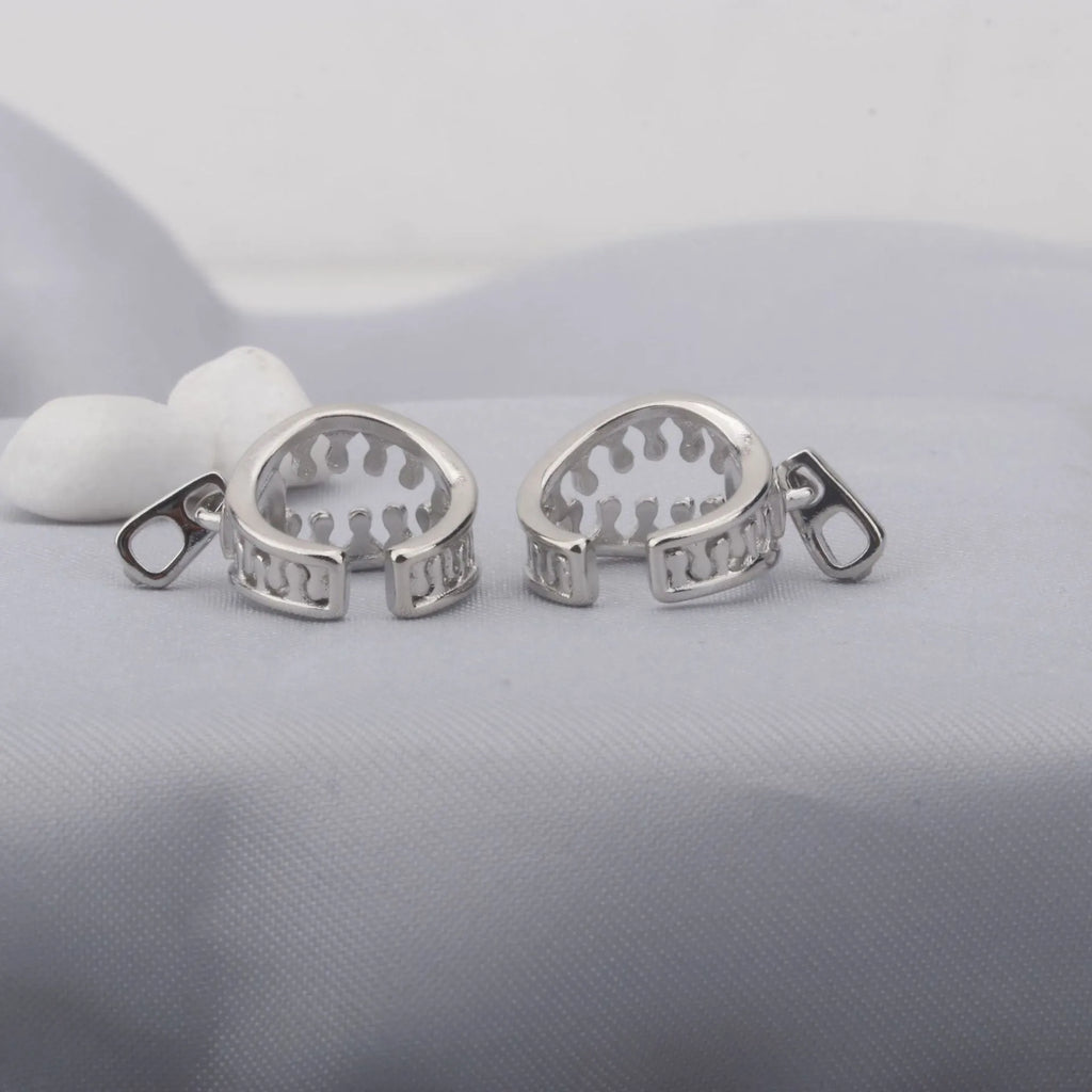 A pair of geometric-shaped copper ear clips with a zipper design detail, colour ES862.
