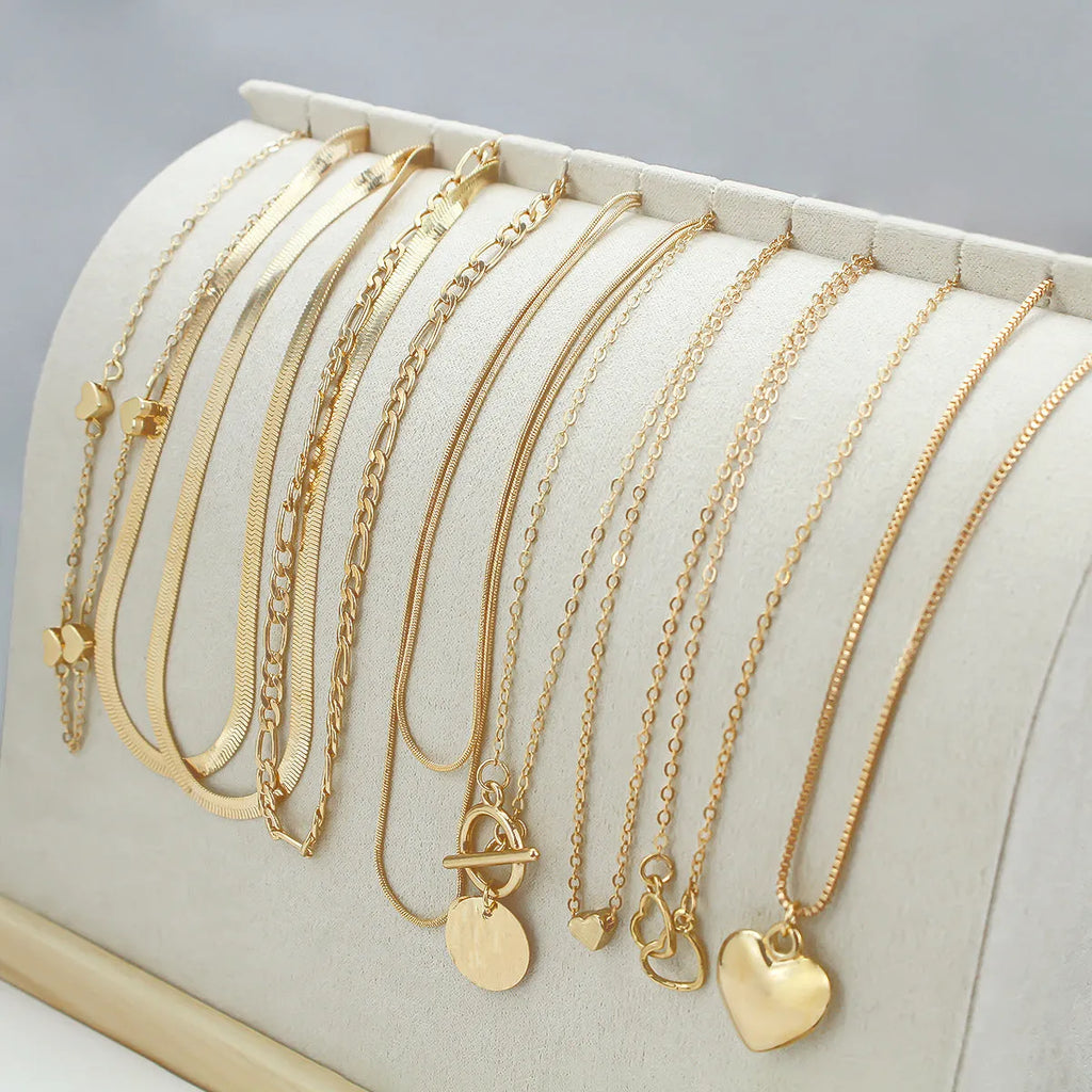 Gold electroplated women's necklace jewellery set with snake chain construction and alloy pendants