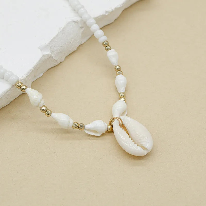 White conch shell bead necklace with mother pearl pendant on regular chain, electroplated finish