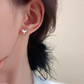 A pair of simple fishtail design earrings with a metallic electroplated finish in either white gold or yellow gold colour.