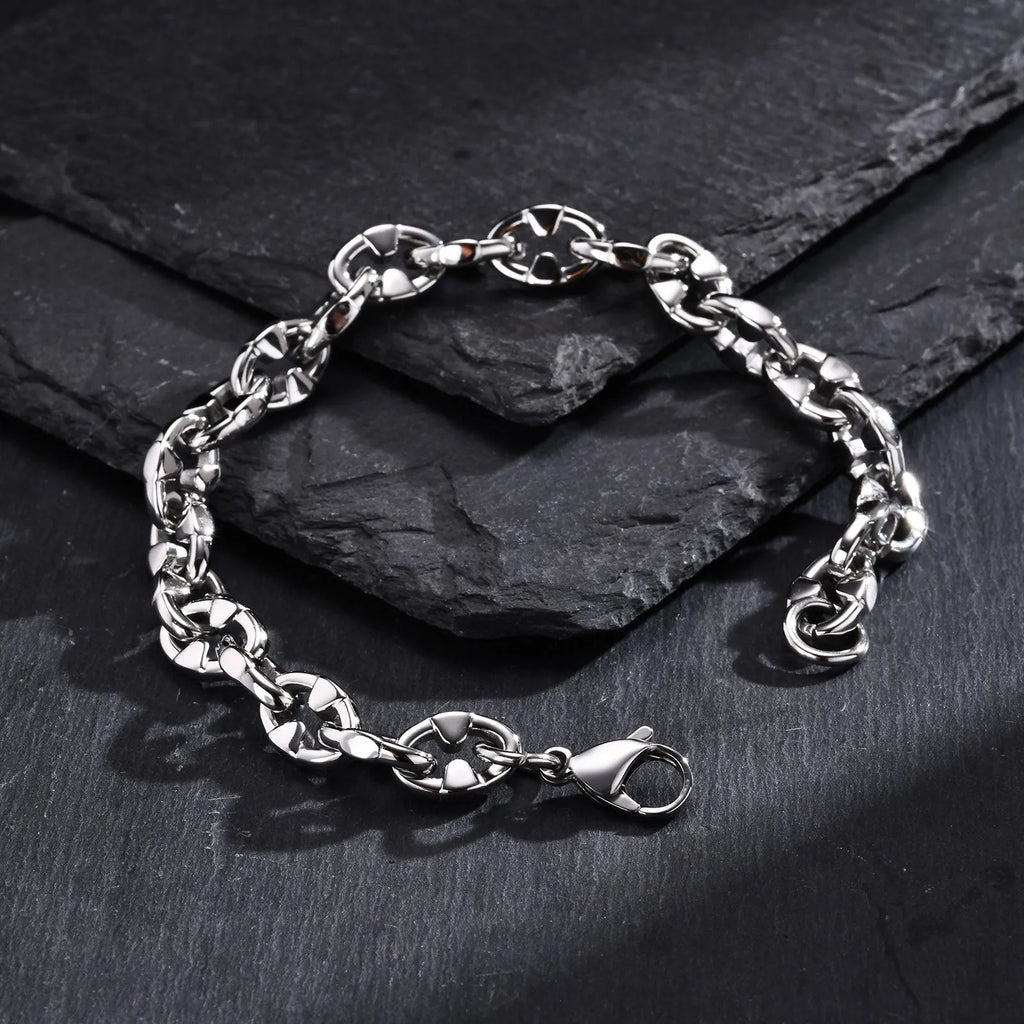 A thick, geometric stainless steel chain bracelet shown on a wrist, highlighting its handmade links and steel colour.