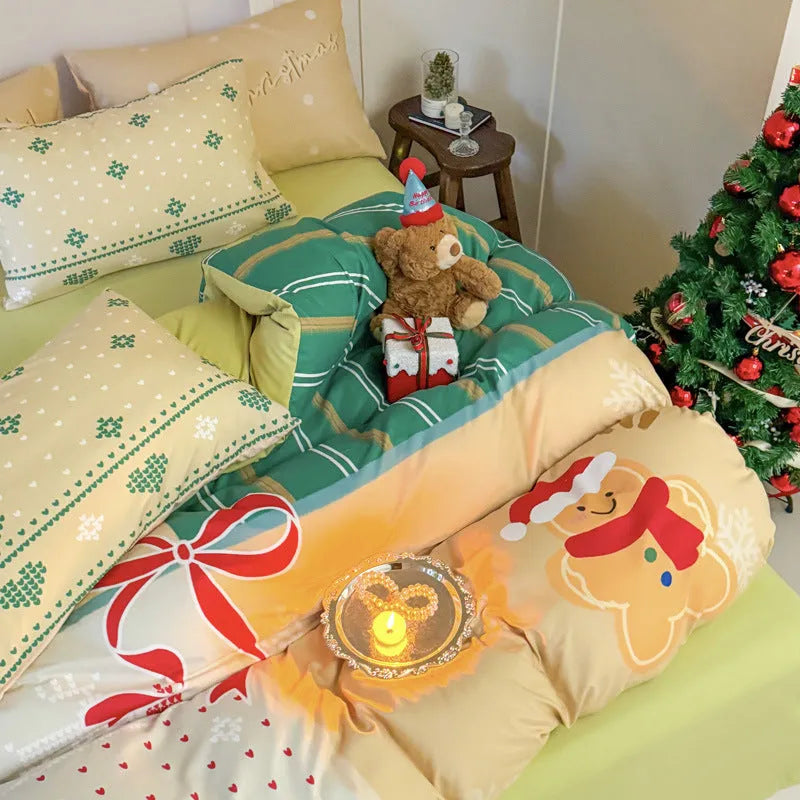 Christmas cartoon themed four-piece bedding set with duvet cover, fitted sheet and pillowcases on a bed.