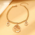 Gold tone spiral donut necklace, bracelet, and earrings set on a white background