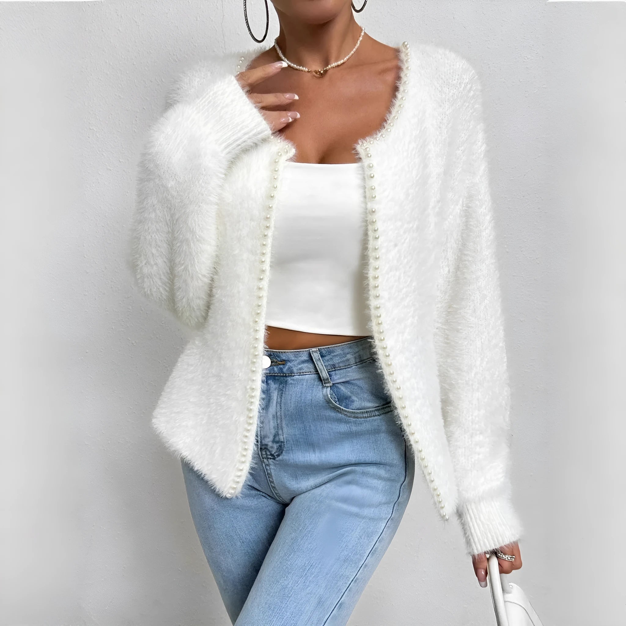 White women's V-neck polyester cardigan on a hanger, showing solid colour and knit texture.