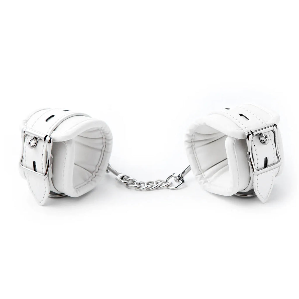 White PU sponge BDSM bondage set showing handcuffs, foot cuffs, and a neck scarf.