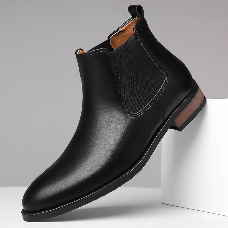 Men's black pointed-toe Chelsea boots with a high-top, mid-calf design and a low rubber sole.