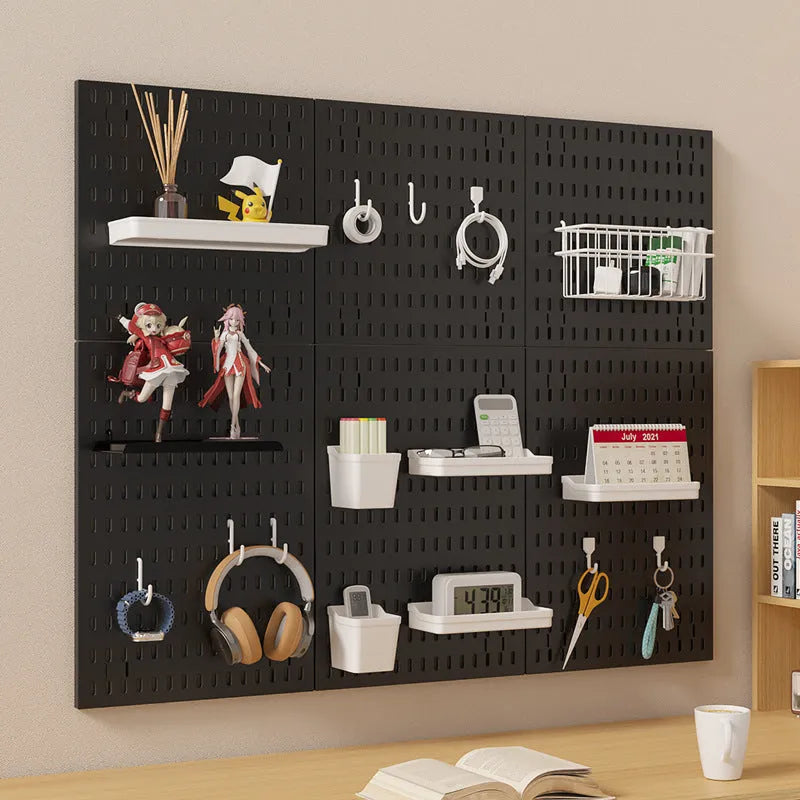 White punch-free wall board with wire-wrap loops holding cables and keys