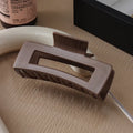 Soft rubber large back head barrette with keel grip, 11cm, in black, showing anti-collision design