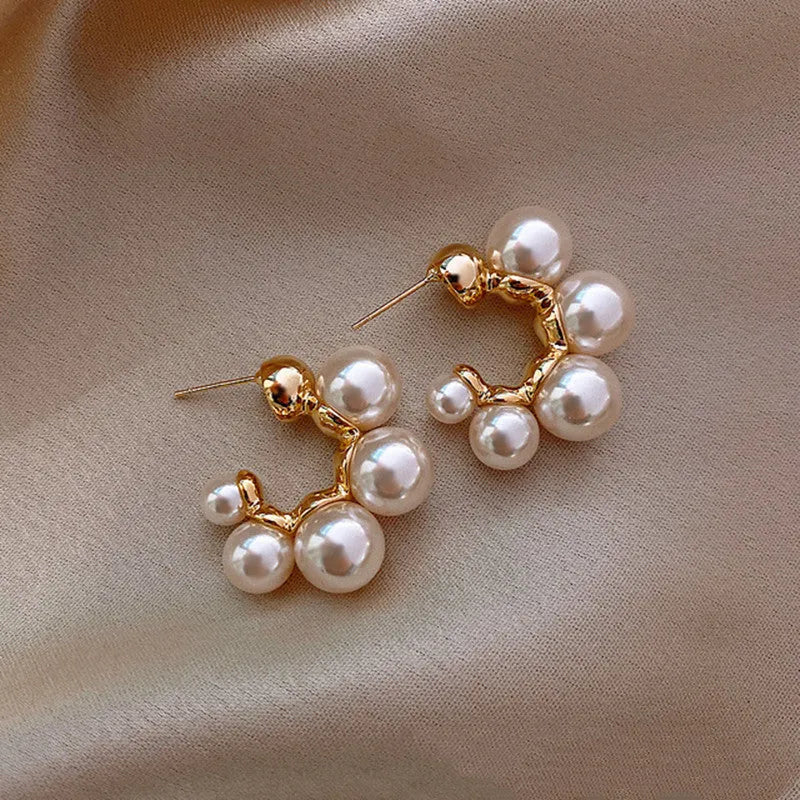 A pair of red dangling bell-shaped alloy earrings for women, also available in white.