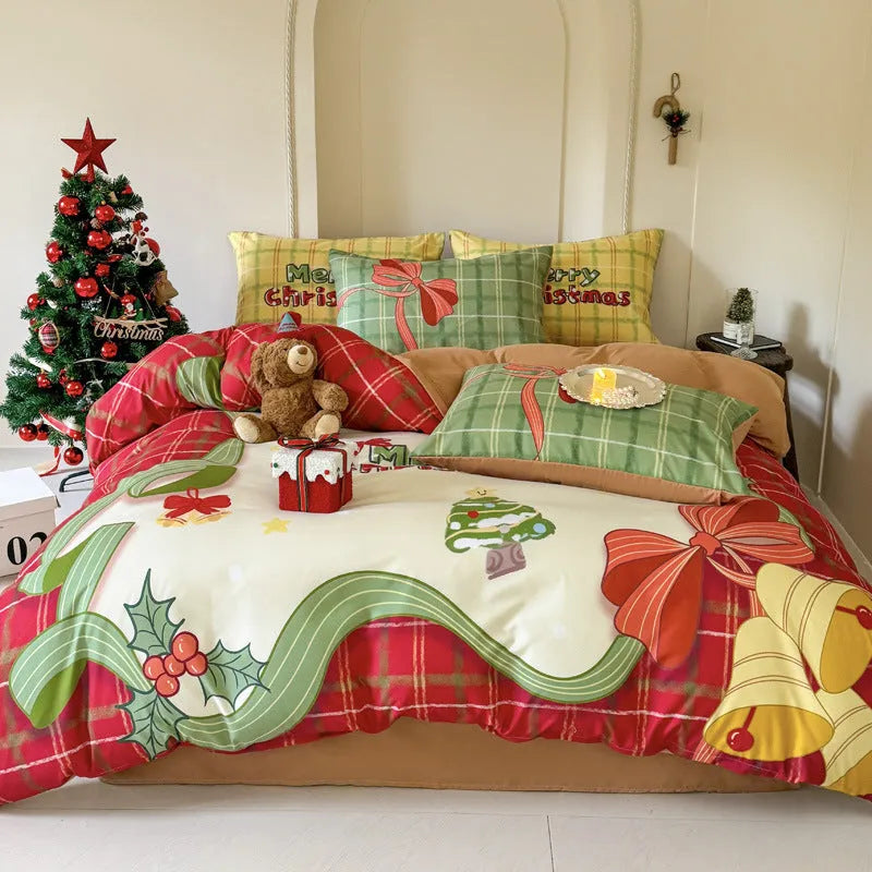 Christmas cartoon themed four-piece bedding set with duvet cover, fitted sheet and pillowcases on a bed.