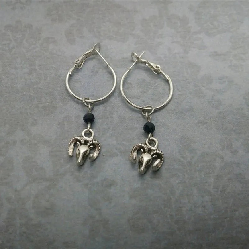 A pair of silver-coloured round ring earrings with a Tibetan Antelope inspired design.