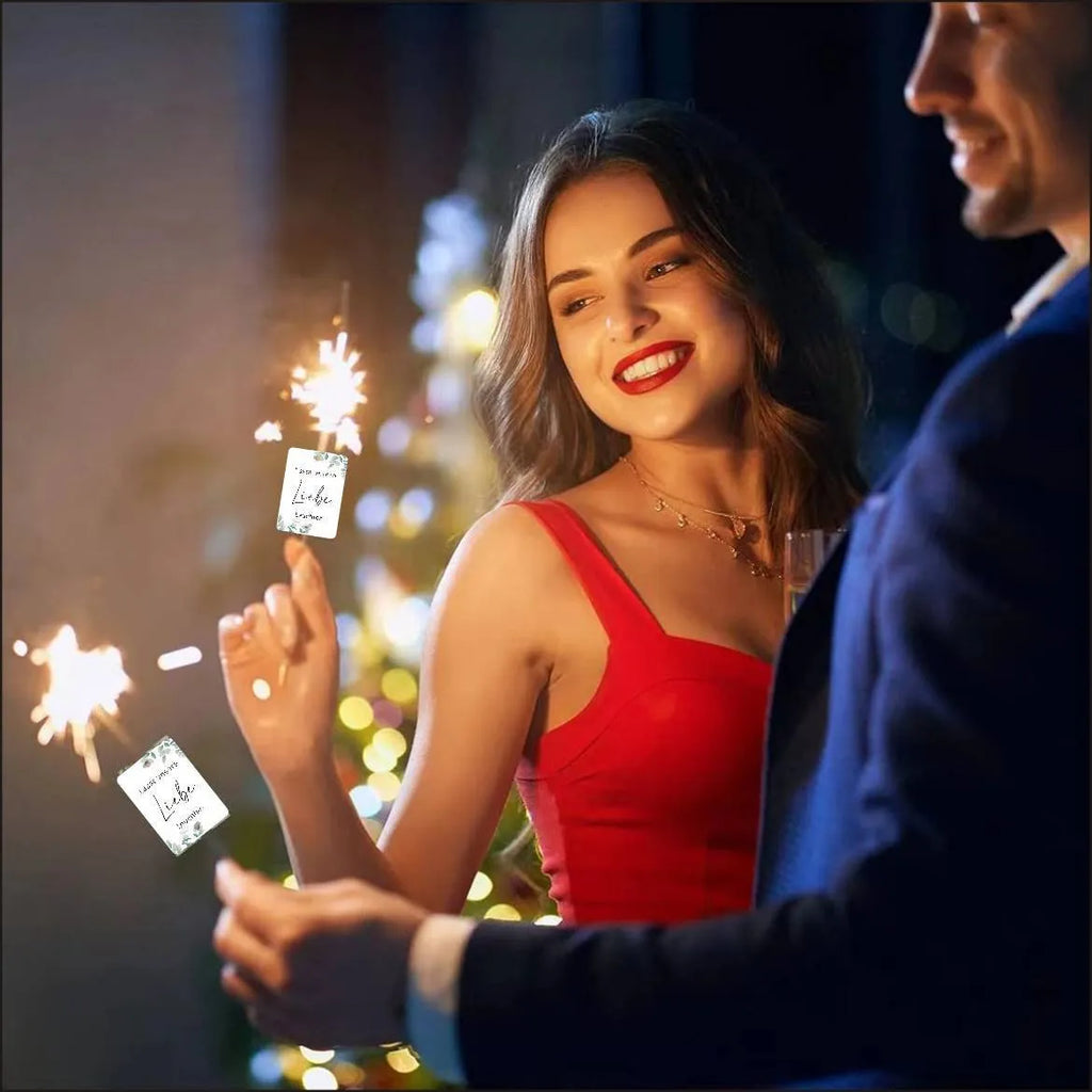 Pack of 50 white decorative paper labels with a red and gold fireworks design for celebrations.