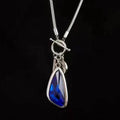 Women's geometric alloy pendant necklace with snake bones chain in blue, champagne, or grey.