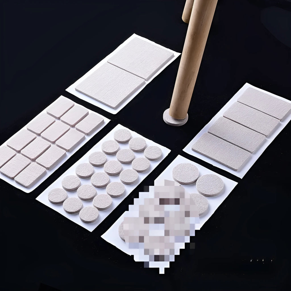 Assortment of beige plastic furniture leg protector pads in round and square shapes on a floor