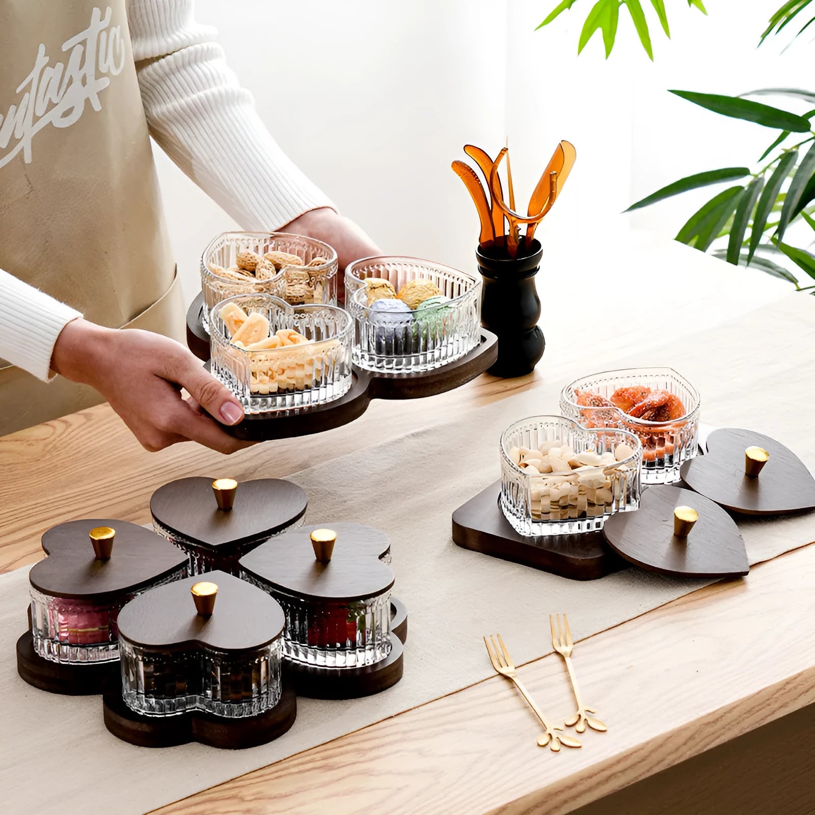 Glass snack platter with choice of 2, 3, 4, or 5 transparent heart-shaped bowls with lids on an irregular tray.