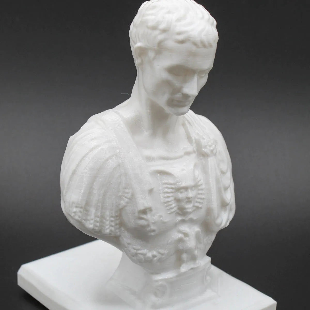 White synthetic resin statue-style pen holder with 15-pen capacity for desk storage