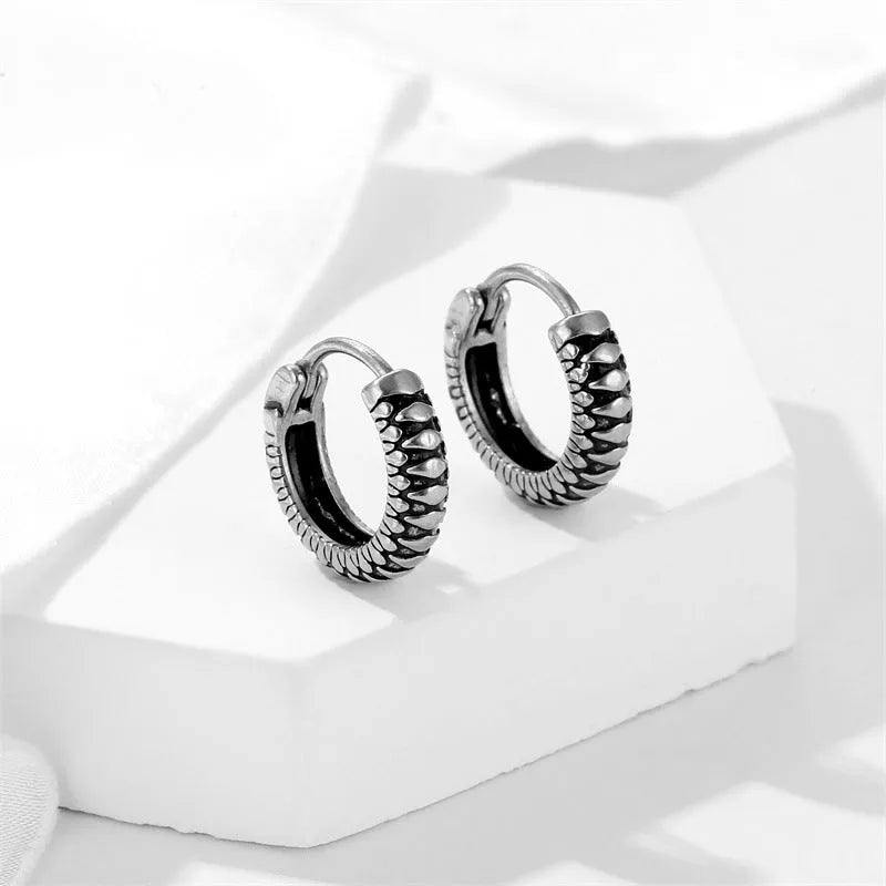 Silver geometric retro twist earrings made from titanium steel alloy with stripe detailing.