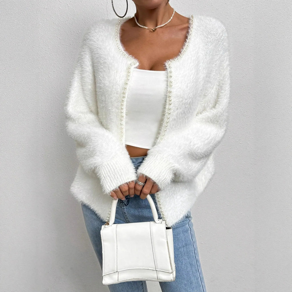 White women's V-neck polyester cardigan on a hanger, showing solid colour and knit texture.