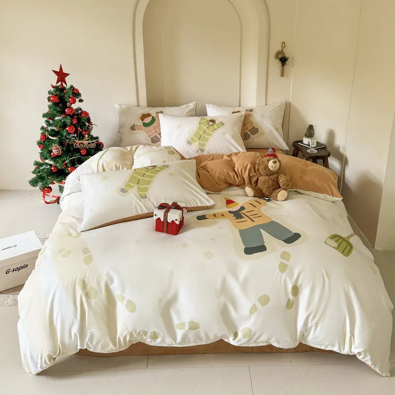 Christmas cartoon themed four-piece bedding set with duvet cover, fitted sheet and pillowcases on a bed.