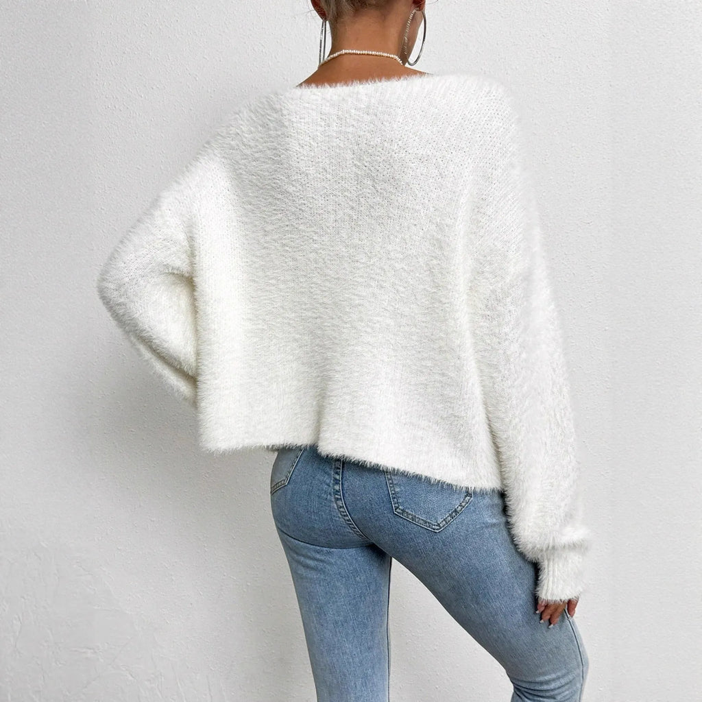 White women's V-neck polyester cardigan on a hanger, showing solid colour and knit texture.