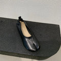 Women's black chunky heel pumps with a round toe and unique split toe peas design.